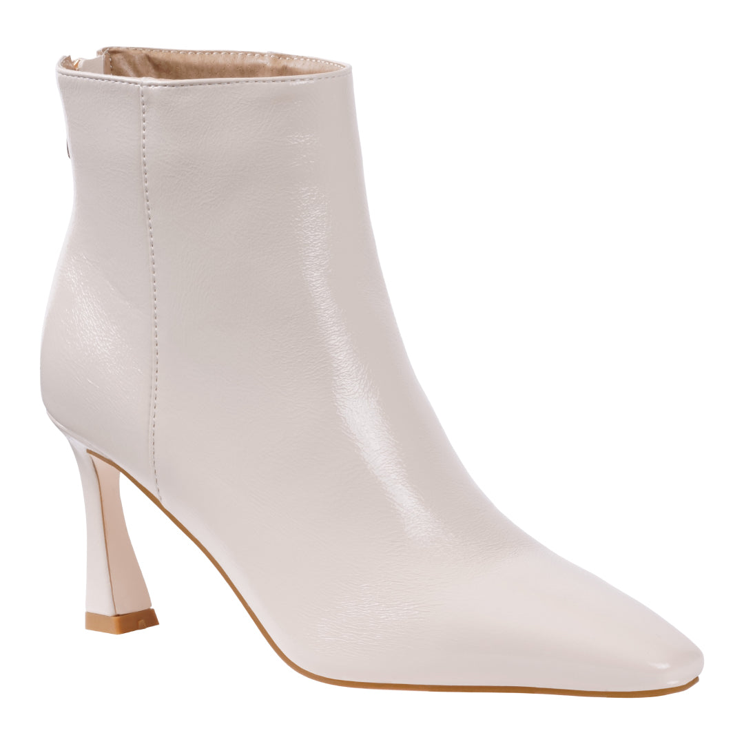Glossy off white pointed toe bootie with flared heel, photo 1 of 5
